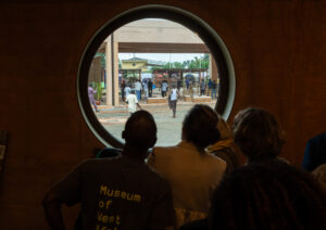 Museum guests watch as protesters interrupt a private opening event at the Museum of West African Art in Benin City, Nigeria, on November 9, 2025. © Toyin Adedokun/AFP/Getty